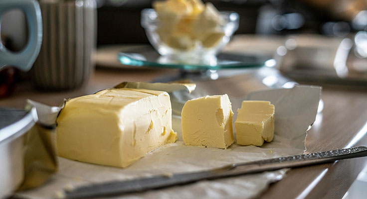 Sliced butter on kitchen counter.