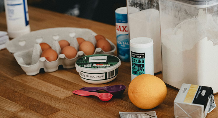 Baking ingredients on a wooden countertop.