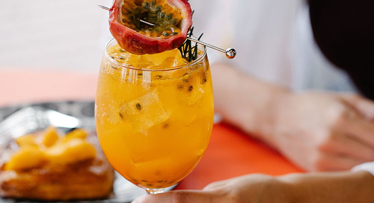 Fresh passion fruit cocktail on table.