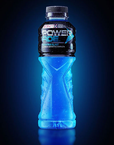 Glowing Powerade sports drink bottle on blue background.