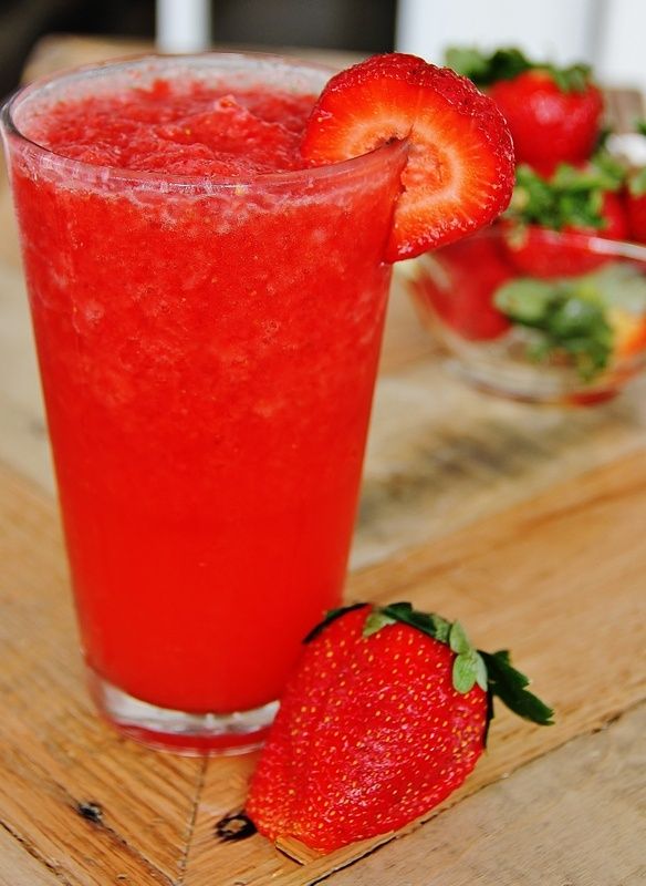 Fresh strawberry smoothie on wooden board.
