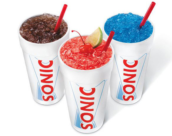Three Sonic slush drinks with straws.