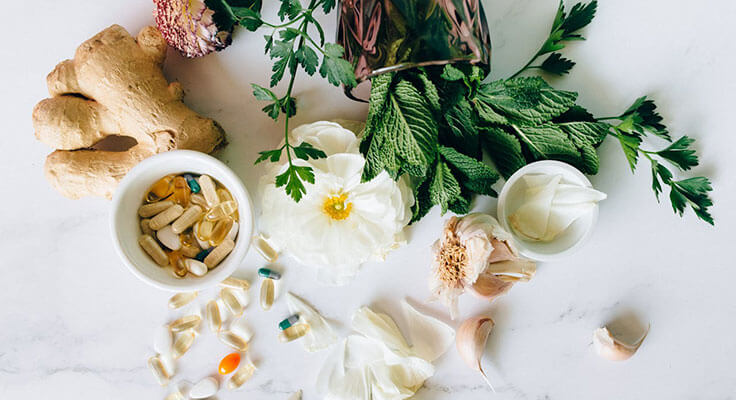Natural supplements and herbs on white background.