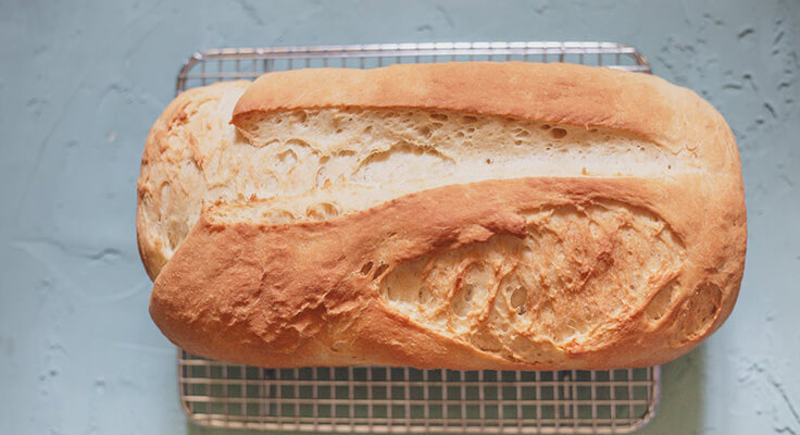 Freshly baked homemade bread on cooling rack.
