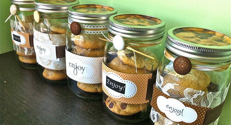 Decorated cookie jars labeled "Enjoy" on a shelf.