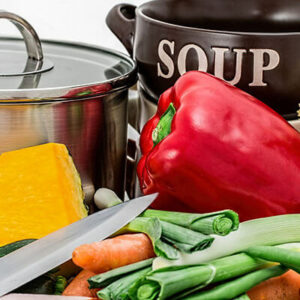 Fresh vegetables with soup pot and ingredients.