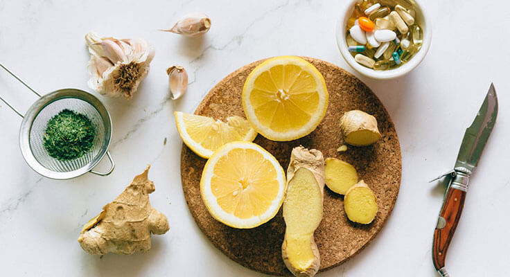 Natural remedies and supplements on marble surface.