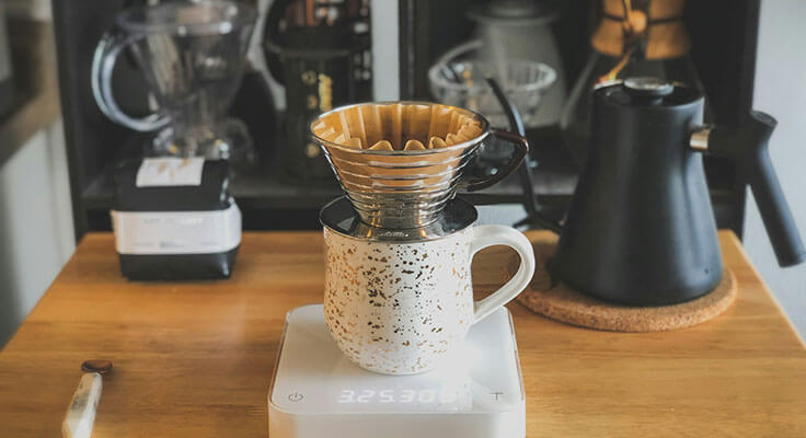 Coffee brewing equipment on wooden countertop.