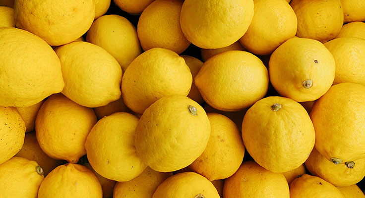 Fresh yellow lemons background.