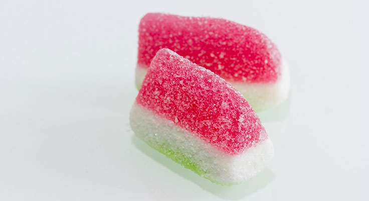 Two watermelon sugar candies on white background.