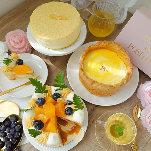 Assorted elegant desserts and cakes on table.