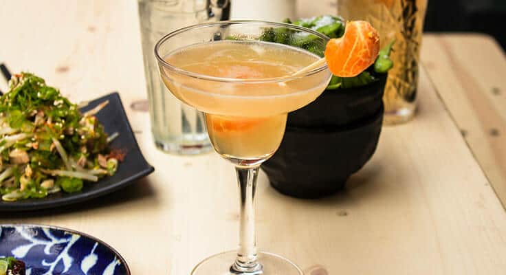Cocktail and salad on dining table.