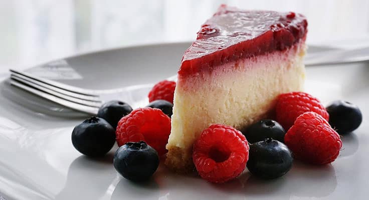 Cheesecake with berries on white plate