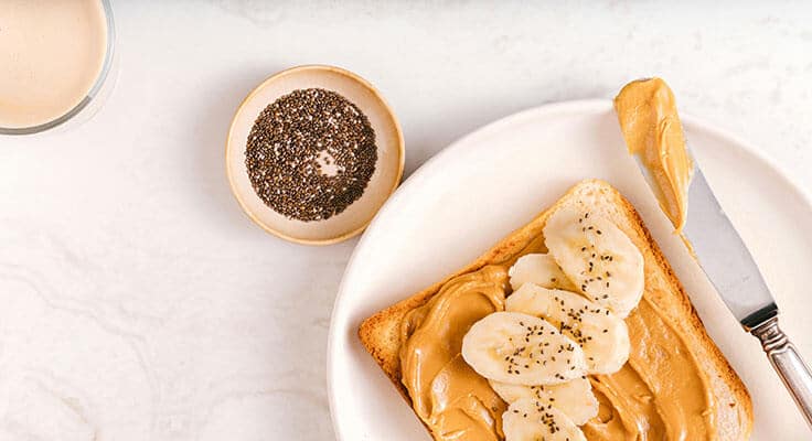 Peanut butter banana toast with chia seeds and coffee.
