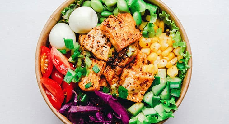 Colorful tofu salad bowl with eggs and vegetables.