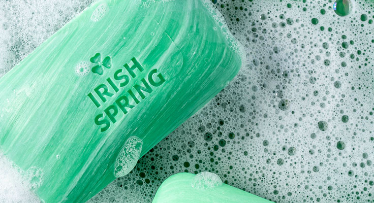 Green soap bar with Irish Spring logo and bubbles.