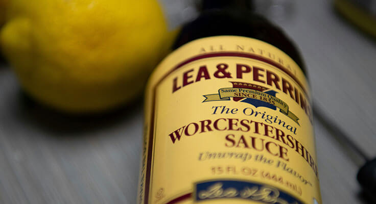 Lea & Perrins Worcestershire sauce bottle with lemon background