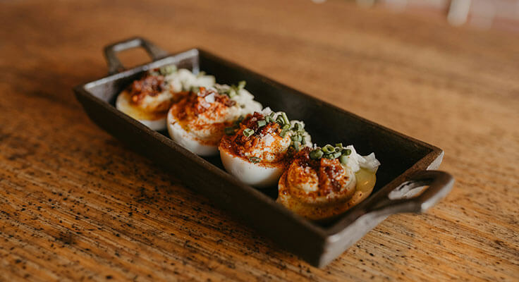 Deviled eggs on wooden table.