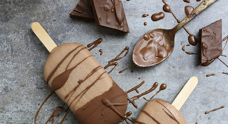 Chocolate ice cream bars with chocolate pieces.