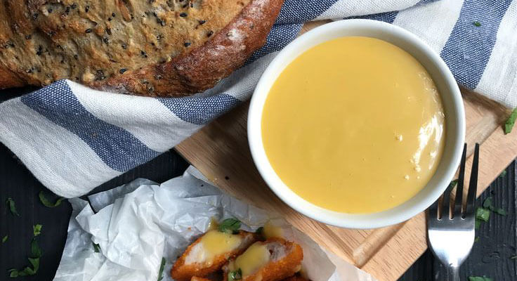Honey mustard sauce with bread and chicken tenders.