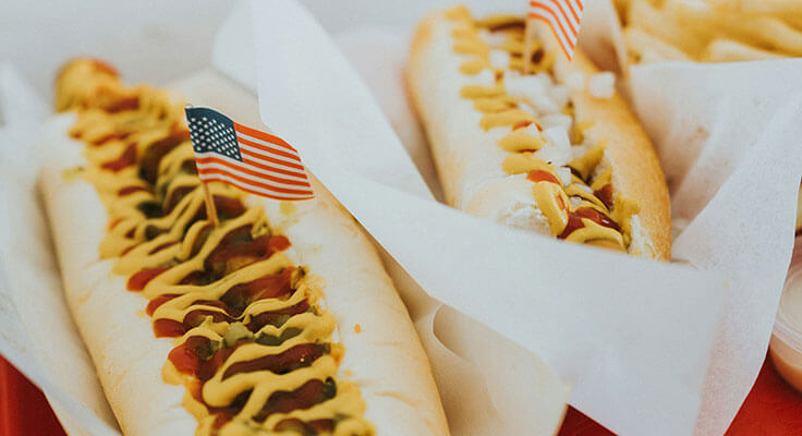 Hot dogs with mustard and American flags