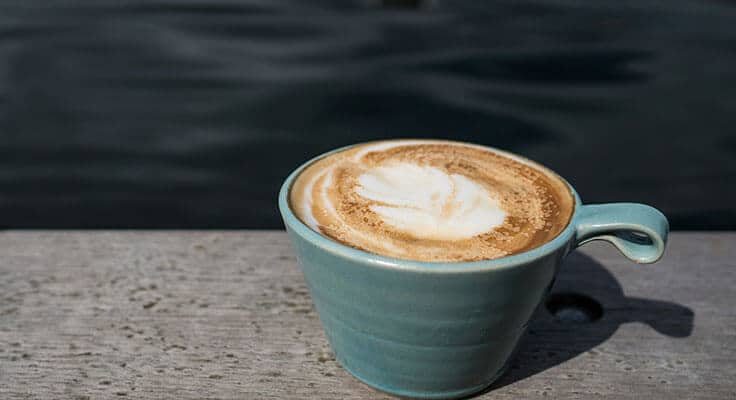 Latte in blue cup outdoors