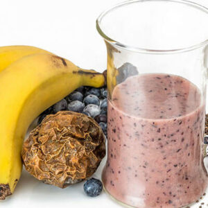 Banana blueberry smoothie with ingredients.