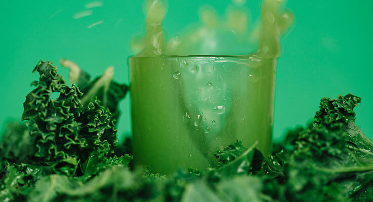 Green juice splash with fresh kale leaves