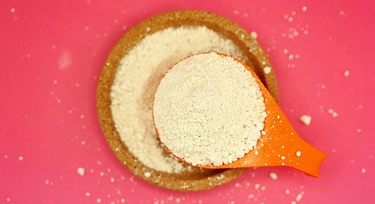 Orange scoop of flour on cork tray