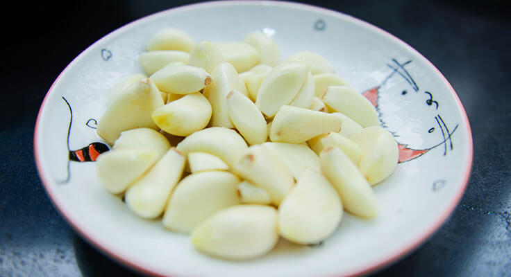 Bowl of peeled garlic cloves