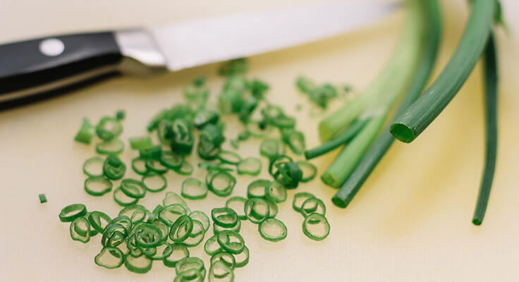 Chopped green onions with knife