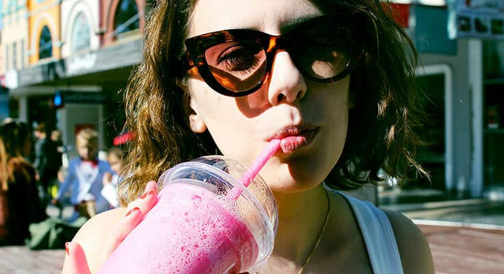 woman drinking the hailey bieber smoothie