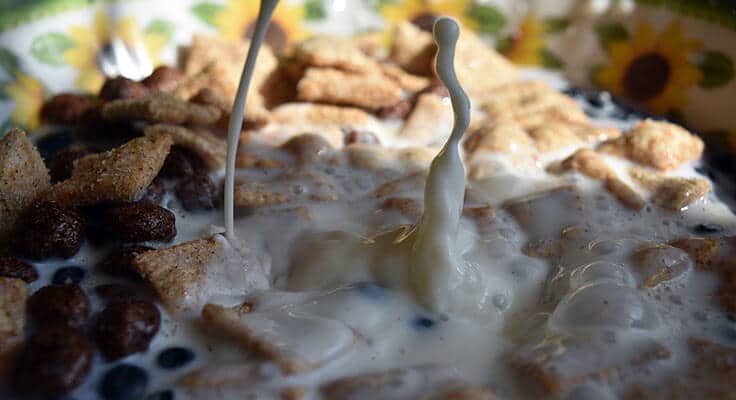 dripping milk into bowl of cereal