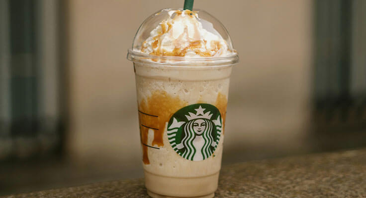 Starbucks caramel Frappuccino on a table.