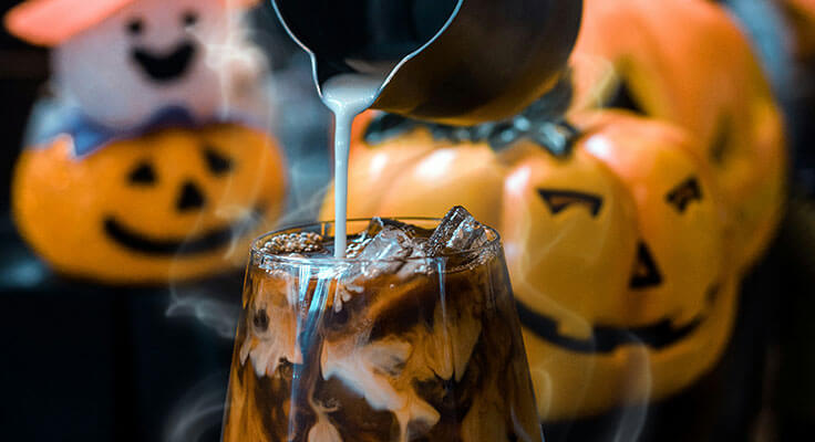 Halloween-themed iced coffee being poured