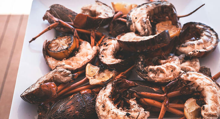 Grilled seafood platter with lobsters and lemon.