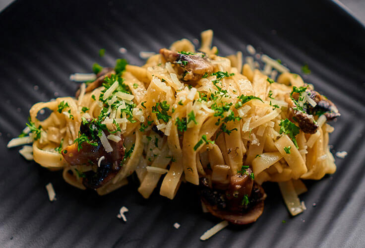 Fettuccine pasta with mushrooms and cheese.