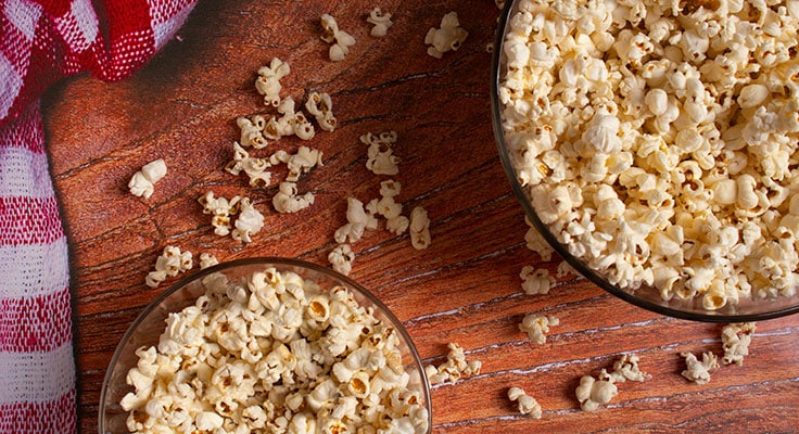Bowl of popcorn on wooden table
