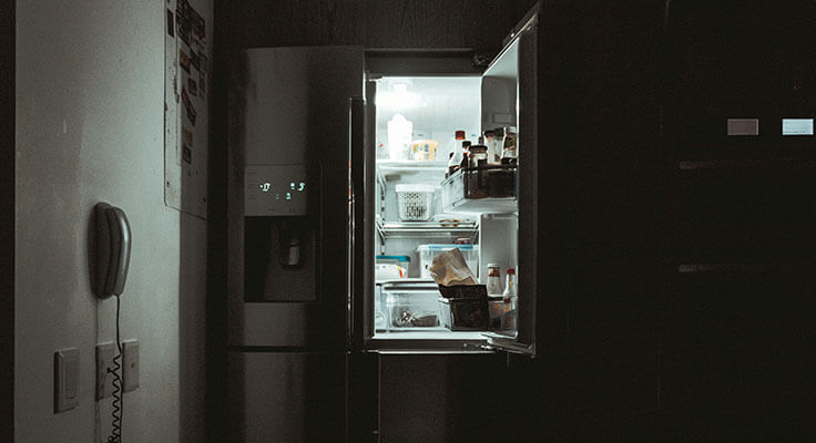 Open refrigerator filled with food and drinks.