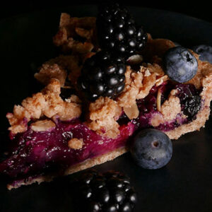 Blackberry blueberry pie slice on a plate