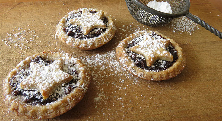 Star-topped mini pies with powdered sugar.